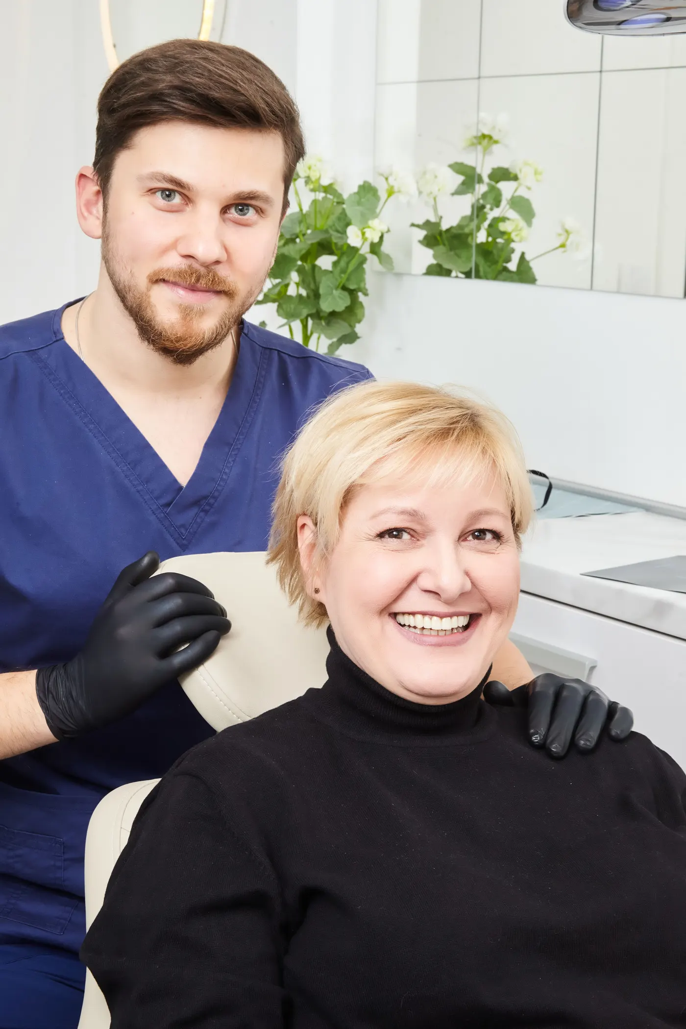 A dentist standing confidently in a treatment room