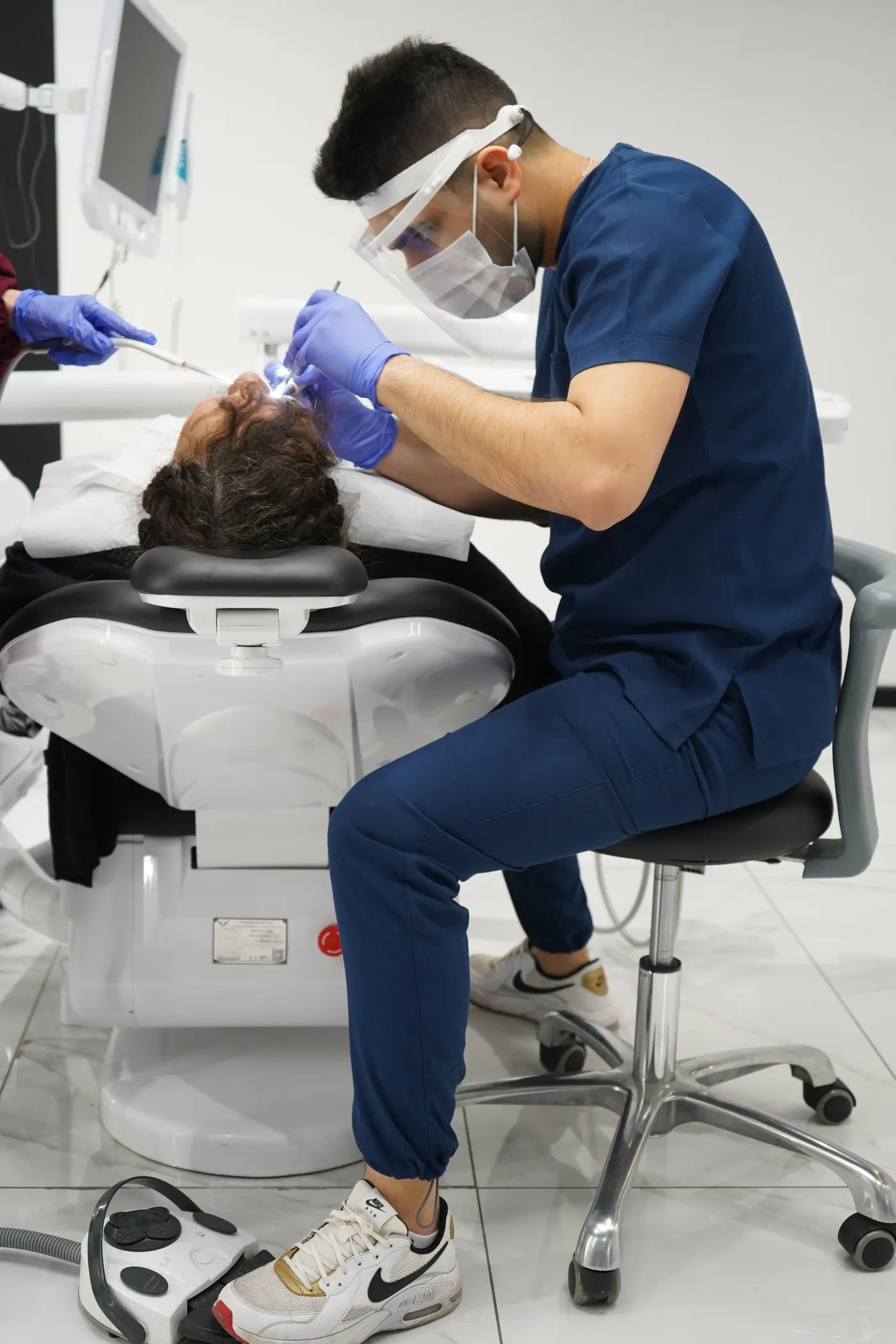 Dentist gently treating a patient